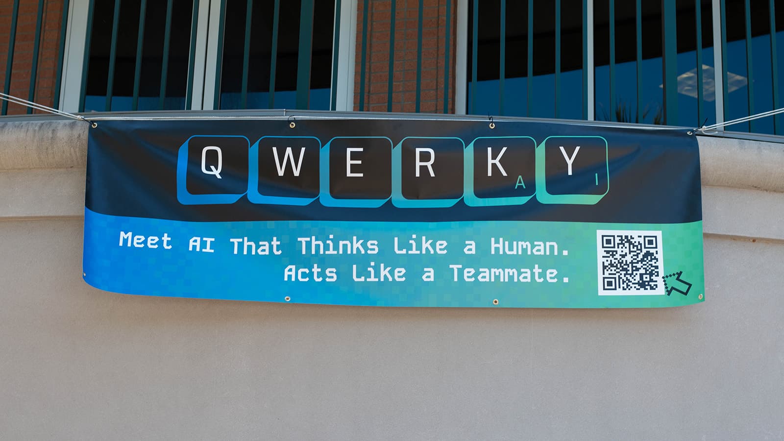 Qwerky AI banner at ribbon-cutting, with QWERKY AI logo, a QR code, and the words "Meet AI That Thinks Like a Human. Acts Like a Teammate"